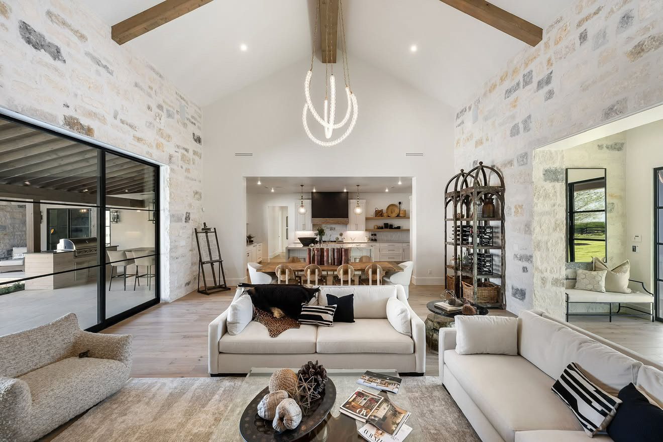 Vaulted great room with limestone walls and exposed beams
